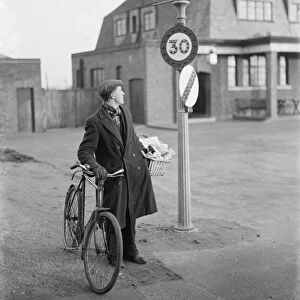 A man looking at a 30 miles per hour speed limit sign in Birchwood, Kent