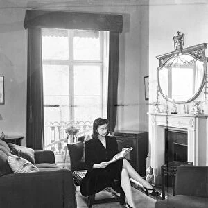 Margot Fonteyn at home. A quiet read by the fireside before leaving for the Royal Opera House
