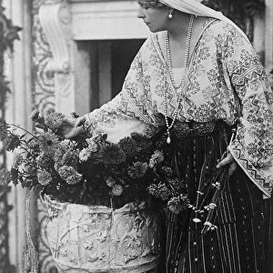 In Memory of Her Baby The Queen of Romania arranging flowers on the grave of little