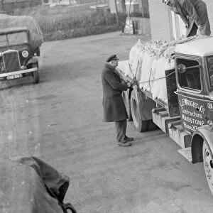Men loading sacks onto an L E Wrights and Company Bedford truck. 1936