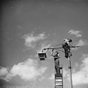 Men painting lamp a standard in Sidcup, Kent. 1938