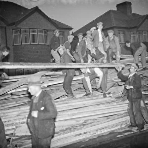 Men rescuing timber from the fire at the timber yard in Welling in Kent