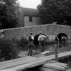 Men at work on river crossing at Eynsford bridge over the River Darent in Kent