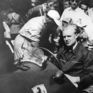 Mike Hawthorn at the wheel of his Ferrari in the pits here when he competed in the