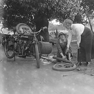 Miss Sybll Arundale and Miss Betty Fairfax out for a motor cycle trip Mending a Puncture