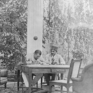 The very modern Amir of Afghanistan. Amanulla Khan, seated beside his telephone