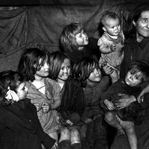 Mother with her seven children all looking very dirty 1948 photograph by John Topham
