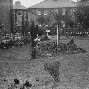 Mr F W Sims stands over his prize garden in Horton Kirby. 1938