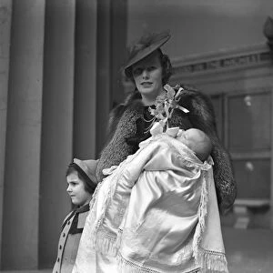 Mrs David Forbes and her infant son after the latters christening at the Guards Chapel