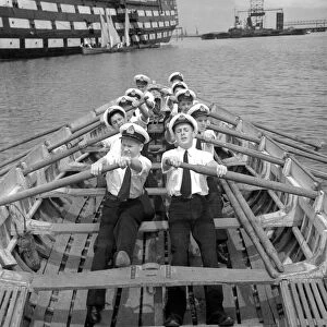 Naval cadets rowing to the training ship HMS Worcester on the River Thames off Greenhithe