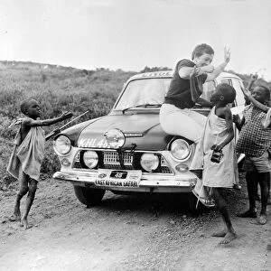 Nr Nairobi, Kenya : British rally driver Pat Moss with East African boys sat