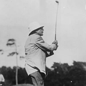 Oil King at golf. Mr J D Rockefeller watching the flight of his ball after a paticularly