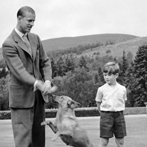 Prince Charles looks on as the Duke of Edinburghs dog Candy plays with his master
