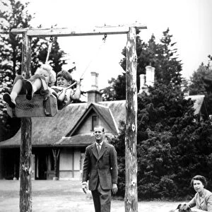 Prince Charles & Princess Anne chuckle delightedly on the swing at Balmoral Castle