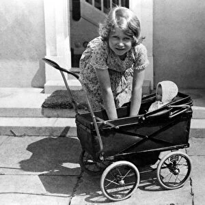 Princess Elizabeth playing with a dolls pram at the little house given to her