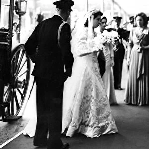 Princess Elizabeth wearing her shimmering pearl encrusted bridal gown arrives at