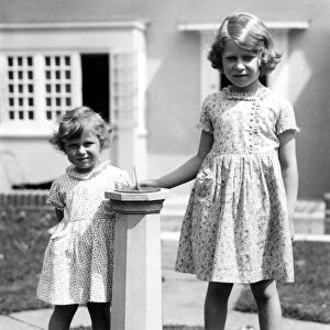 Princess Margaret and Princess Elizabeth outside the little house given to her