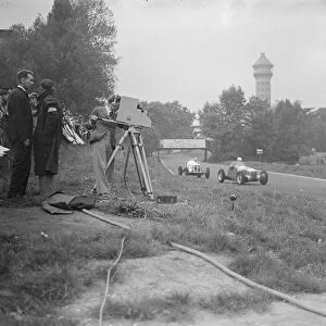 The race being televised in front is count Johnny Lurani the Italian driver in his Maserati