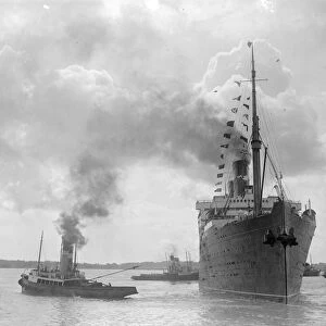 The RMS Berengaria sails with the Prince of Wales on board. The beflagged liner
