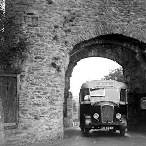 Rye bus passing through arch at Rye Tower in Sussex. 1934
