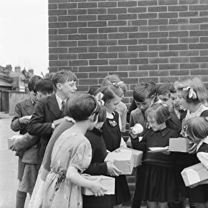 School children at Sidcup Hill School, Kent, with their coronation mugs received