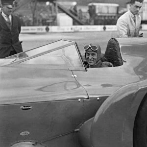 Sir Malcolm Campbell in the cockpit of Bluebird car being rolled out on Easter Monday