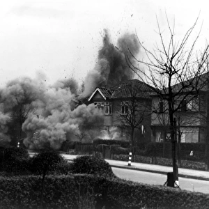 Smoke and debris thrown skywards after a direct hit from a German bomb in the suburbs