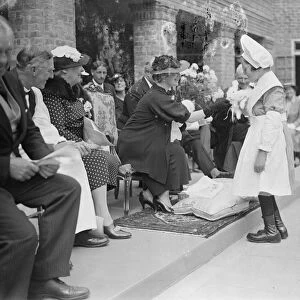 The Suchess pets a rabbit. She visitied Schools in Chailey. The Duchess of York