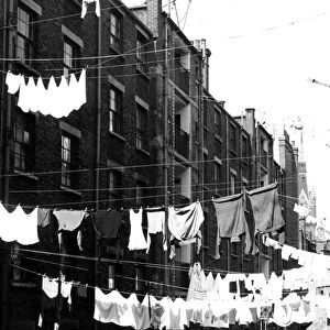 Tenements in St Pancras, London with laundry hanging from washing lines strung