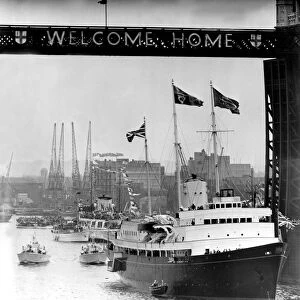 Under Tower Bridge- and the Welcome Home sign - passes the majestic looking Britannia