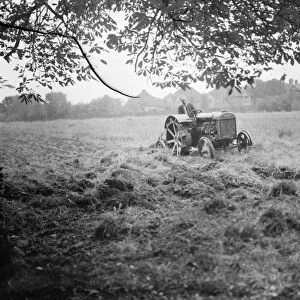 A tractor ploughing a cherry orchard in Charlton, London. 1939