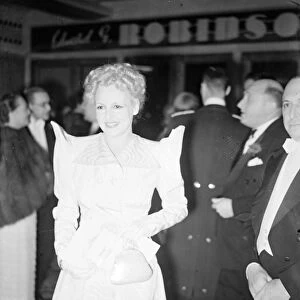 An unusual fashion worn by attractive Mrs Max Milder when she arrived for the opening