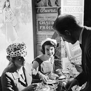 A waiter serves two ladies at lunch in Le P tit Monmartre, Marylebone Lane, London
