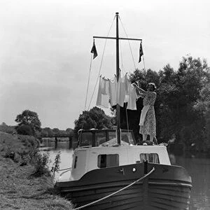 Washing day on holiday - Mrs M Usborne hanging out the washing around the mast of