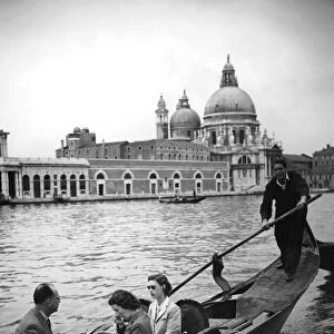 Wearing dark glasses Princess Margaret starts off for her tour of the Grand Canal