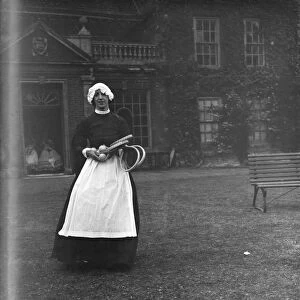 A woman in a servants period dress at Lullingstone Park near Eynsford, Kent
