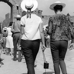 Two women tourists visiting Pompeii in Italy in the 1950s