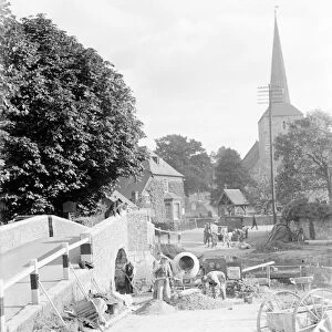 Workers building a ford water crossing by the Eynsford bridge over the River Darent
