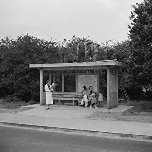 Workes on top of a bus shelter in Chislehurst, Kent. 1936