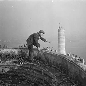 A workman waves down from one of the chimneys of the new coal electric power station