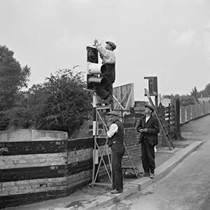 Workmen work on traffic lights in Swanley. 1936