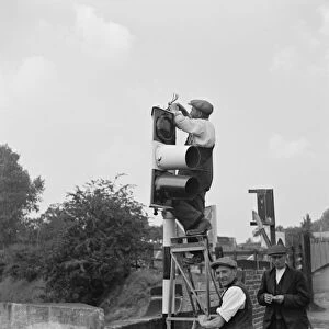Workmen work on traffic lights in Swanley. 1936
