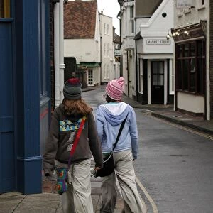 Young fashion: two teenage girls wearing baggy trousers that drag on the ground and get dirty