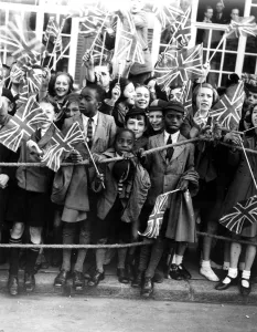 14 October 1938 Crowds of children cheering Queen Mary where she opened a new extension 14 October 1938 Crowds of children cheering Queen Mary where she opened a new extension