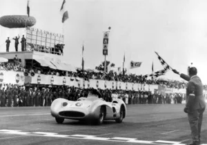 Argentines car ace Juan Manuel Fangio in a Mercedes Bez is flagged in winner of Argentines car ace Juan Manuel Fangio in a Mercedes Bez is flagged in winner of