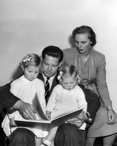 A bedtime story for Princess Margaret (3 1/2) and Princess Helen (2) is read by father A bedtime story for Princess Margaret (3 1/2) and Princess Helen (2) is read by father