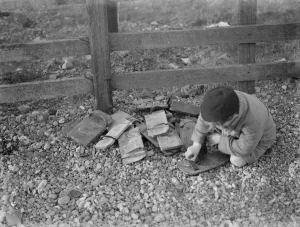 Children playing on the shingle beach at Dungeness. A child trys on a special Children playing on the shingle beach at Dungeness. A child trys on a special