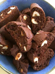 Chocolate and almond cookies in blue ceramic bowl credit: Marie-Louise Avery / Chocolate and almond cookies in blue ceramic bowl credit: Marie-Louise Avery /