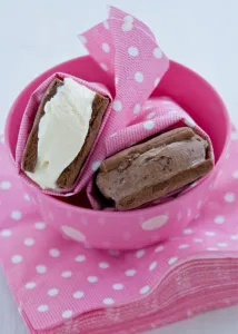 Chocolate and vanilla icecream in homemade chocolate biscuits wrapped in spotty pink Chocolate and vanilla icecream in homemade chocolate biscuits wrapped in spotty pink