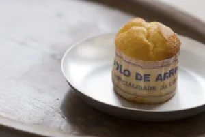 Classic Portuguese muffin type cake made with rice in paper wrapper on metal plate Classic Portuguese muffin type cake made with rice in paper wrapper on metal plate
